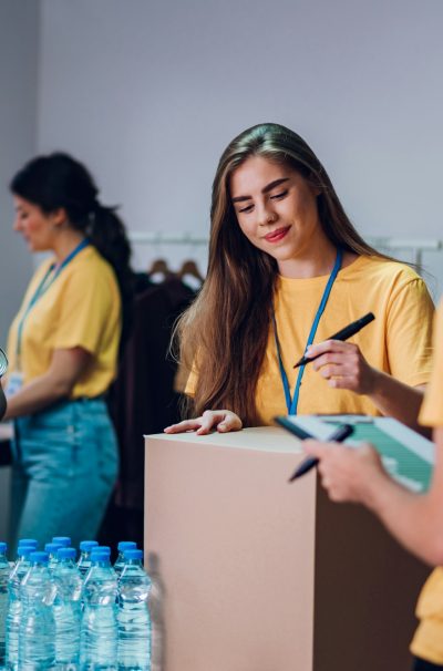 Group of multiracial volunteers working in community charity donation center